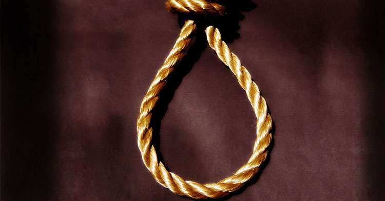 Nudo de cuerda de color dorado sobre un fondo oscuro, representando un lazo.